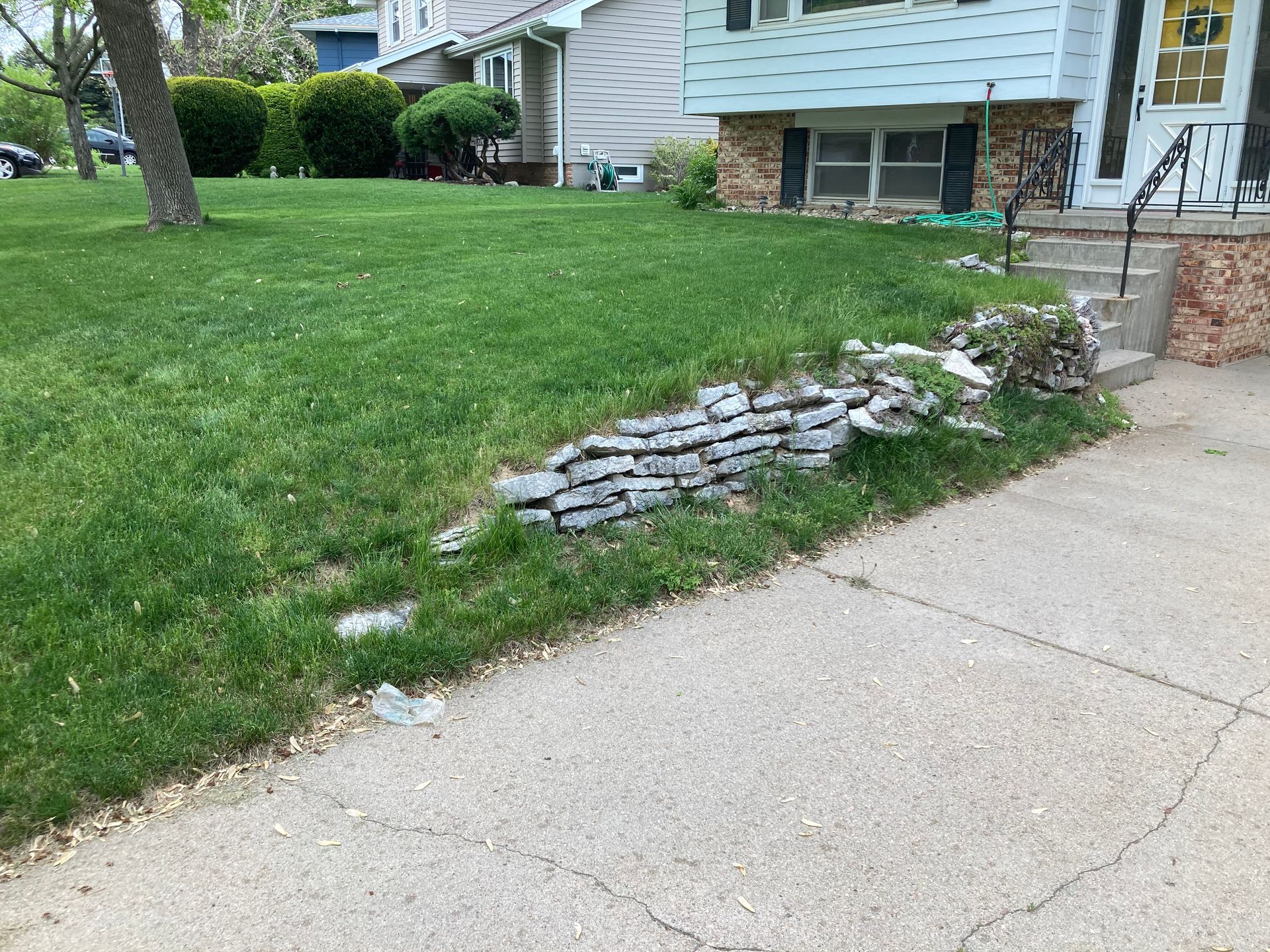 a house with a lawn and a sidewalk in front of it