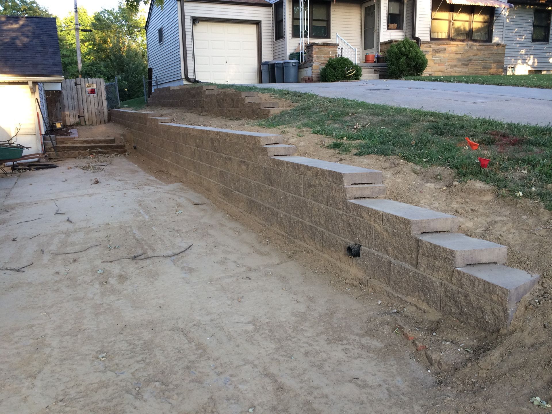 a brick wall is being built in front of a house
