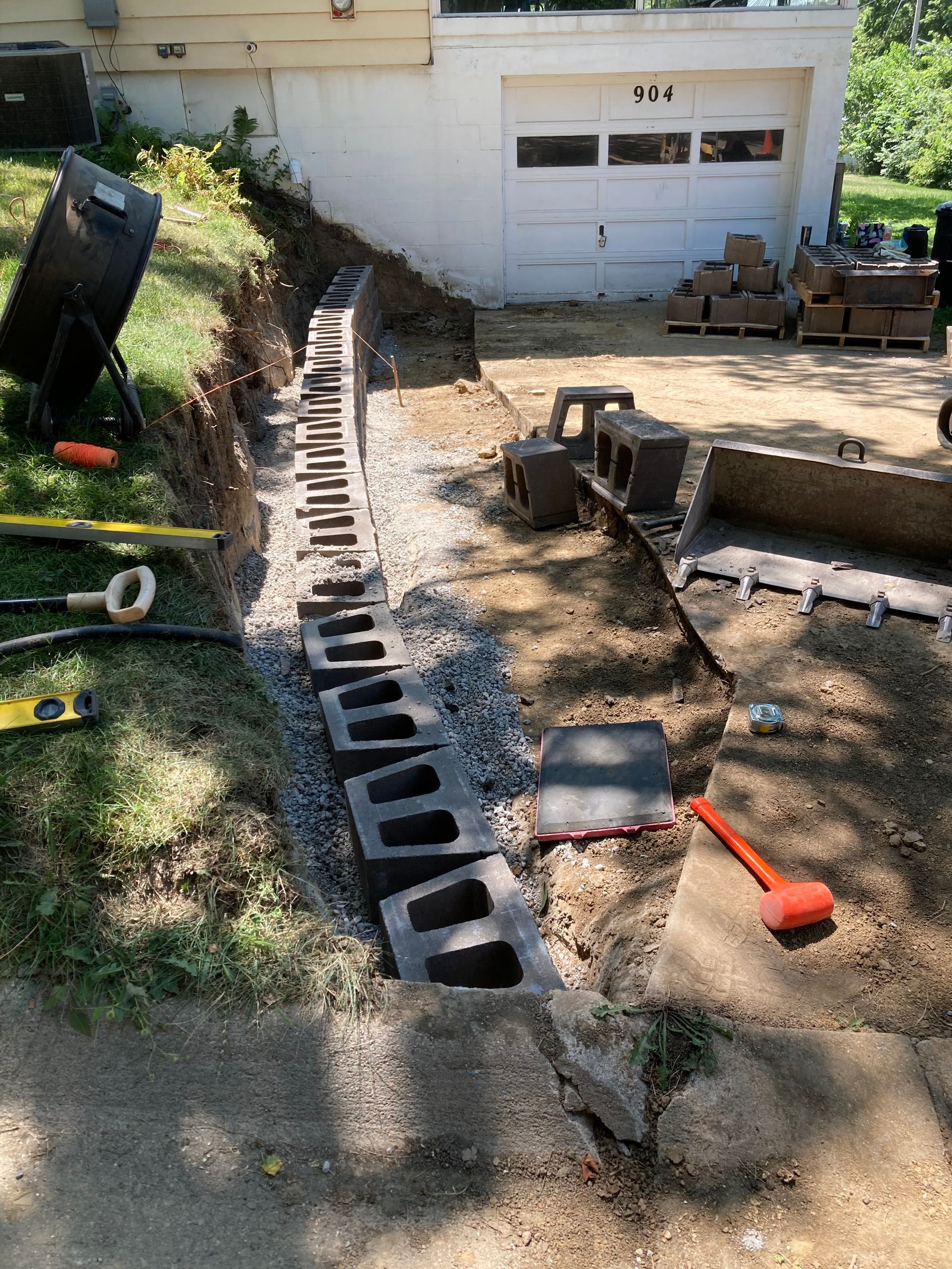 a concrete wall is being built in front of a house
