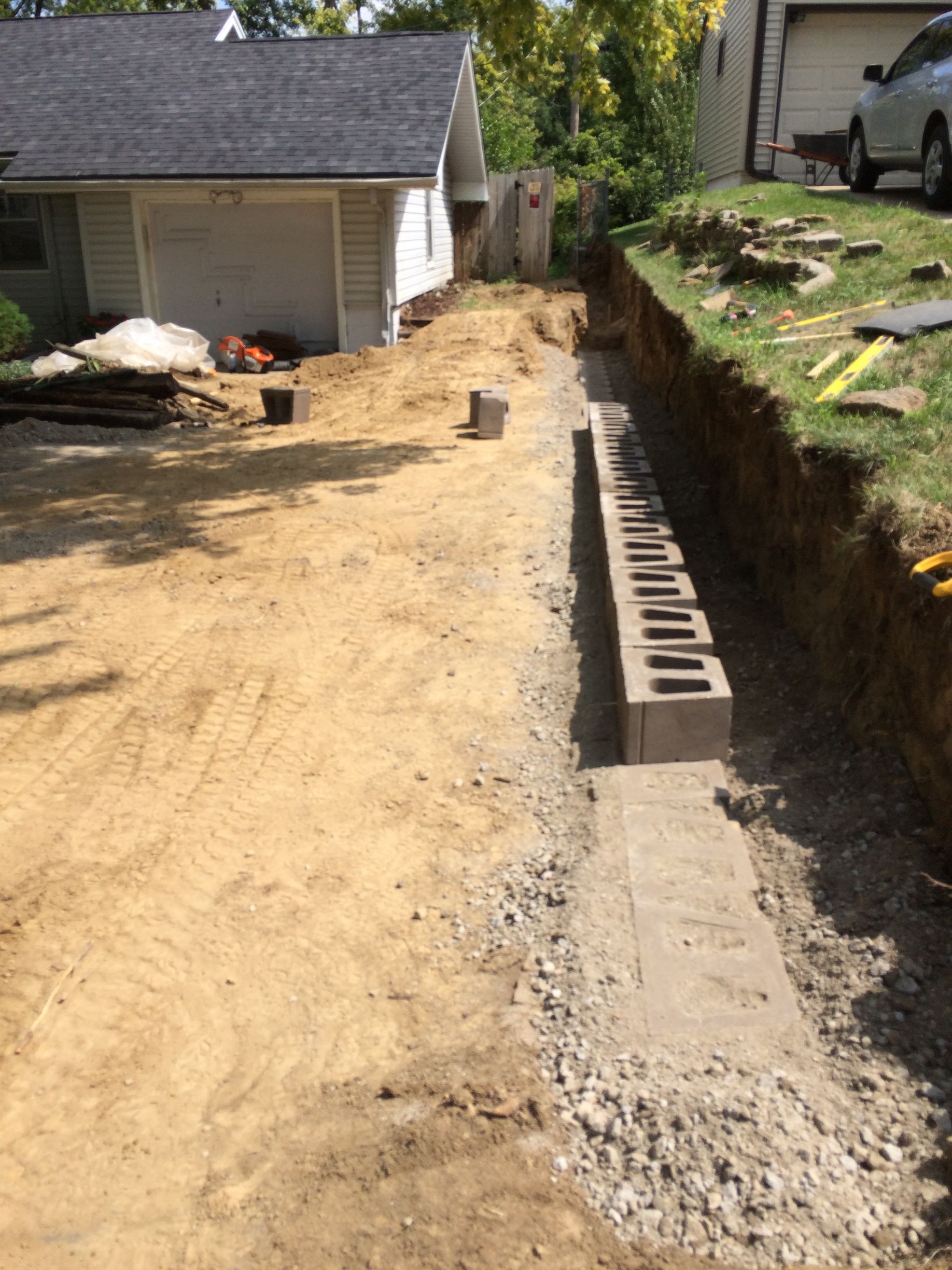 a concrete wall is being built in front of a house