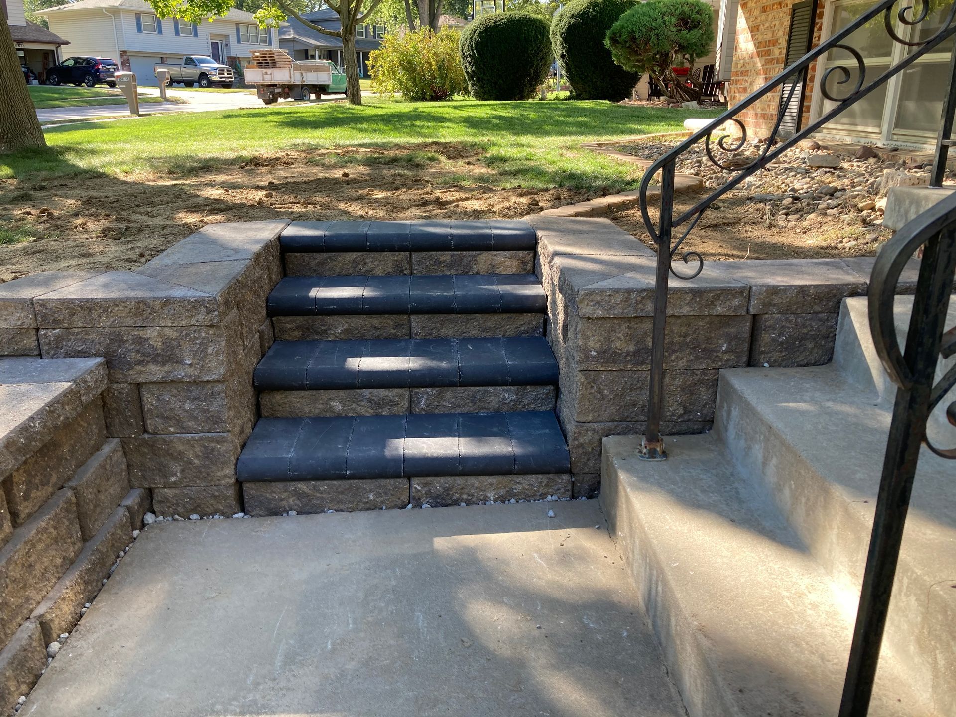 a set of stairs leading up to a house with a wrought iron railing