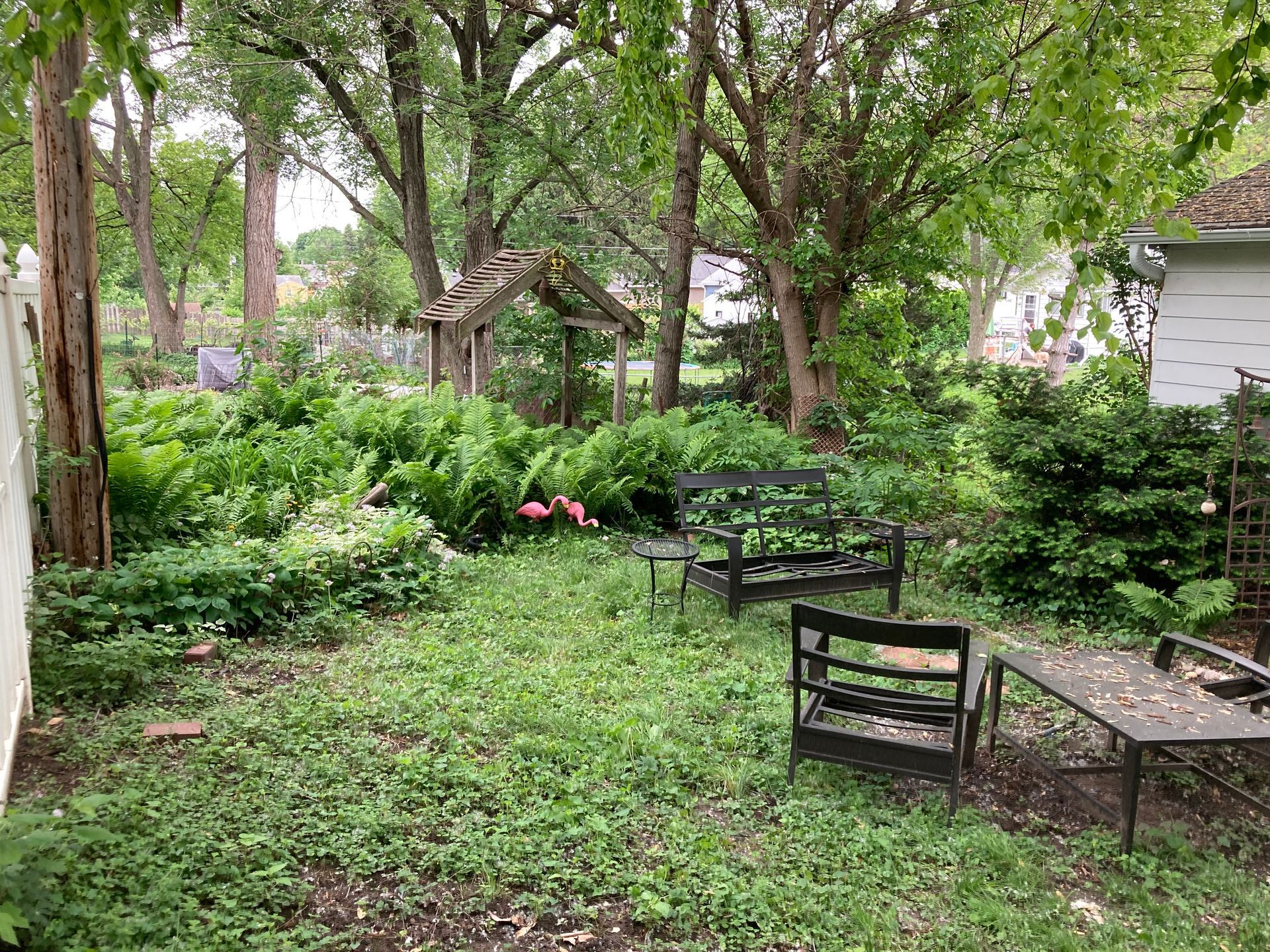 a backyard with a table and chairs in the middle of it