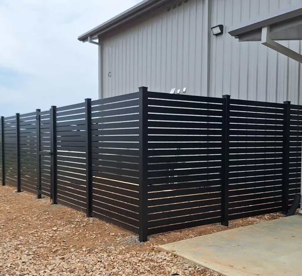 Black horizontal slat fence around building.