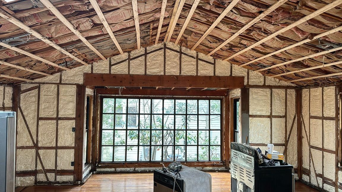 Interior construction: Walls and ceiling are insulated with brown spray foam; large window in the center.
