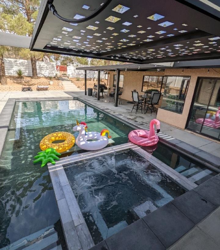 A swimming pool with a flamingo float in it