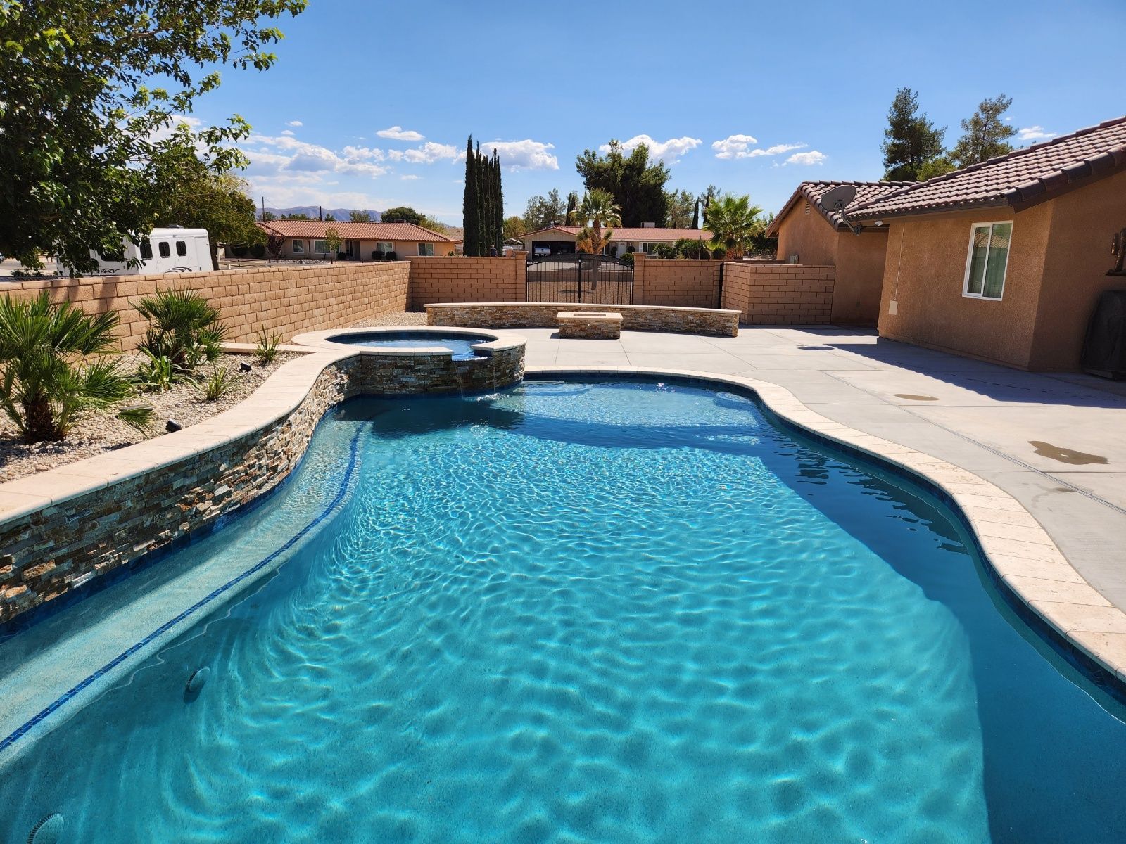 A large swimming pool in the backyard of a house