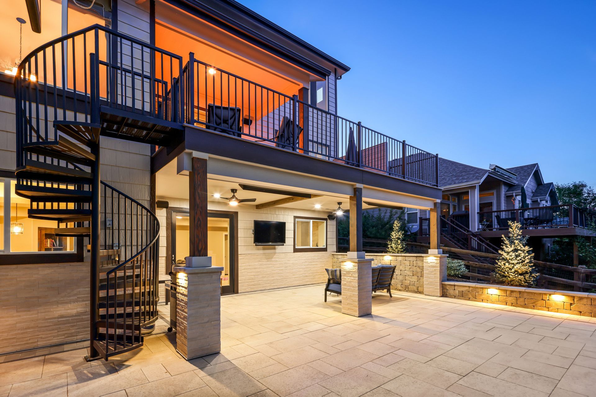 a large house with a spiral staircase and a large deck