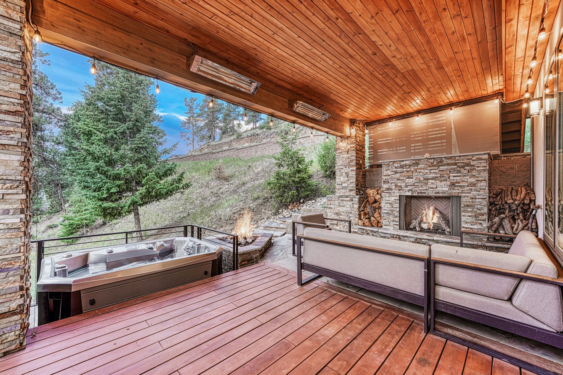 a wooden deck with a fireplace and a couch on it