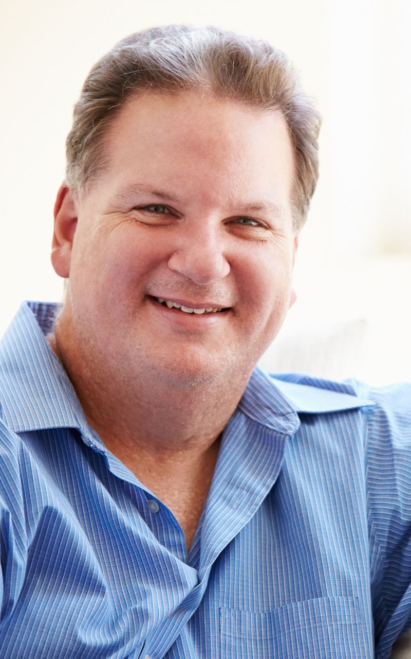 Smiling man in blue shirt.