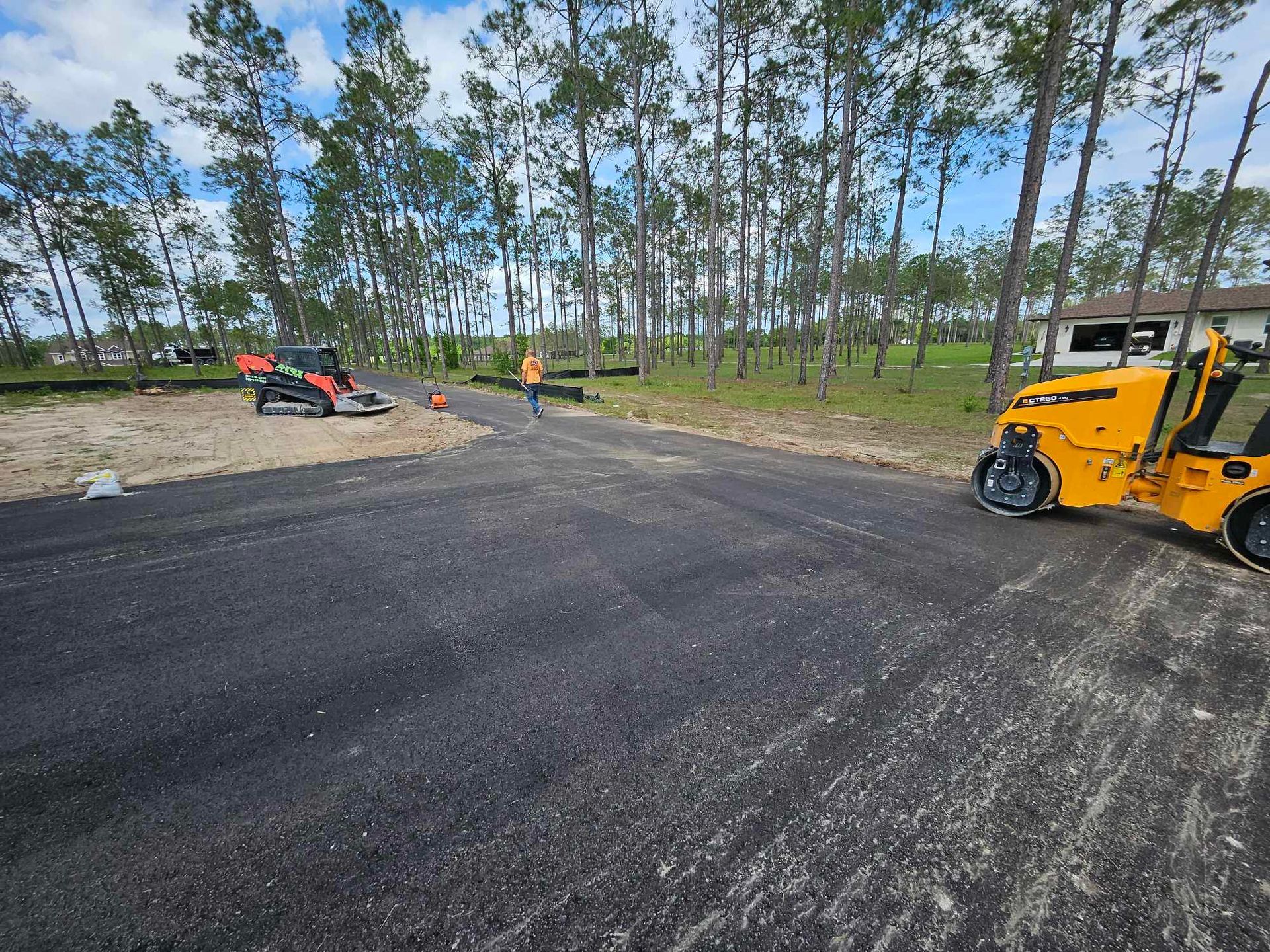 A yellow roller is sitting on the side of a road
