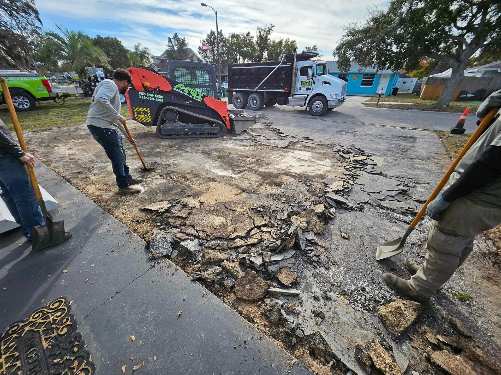 A group of people are working on a road 