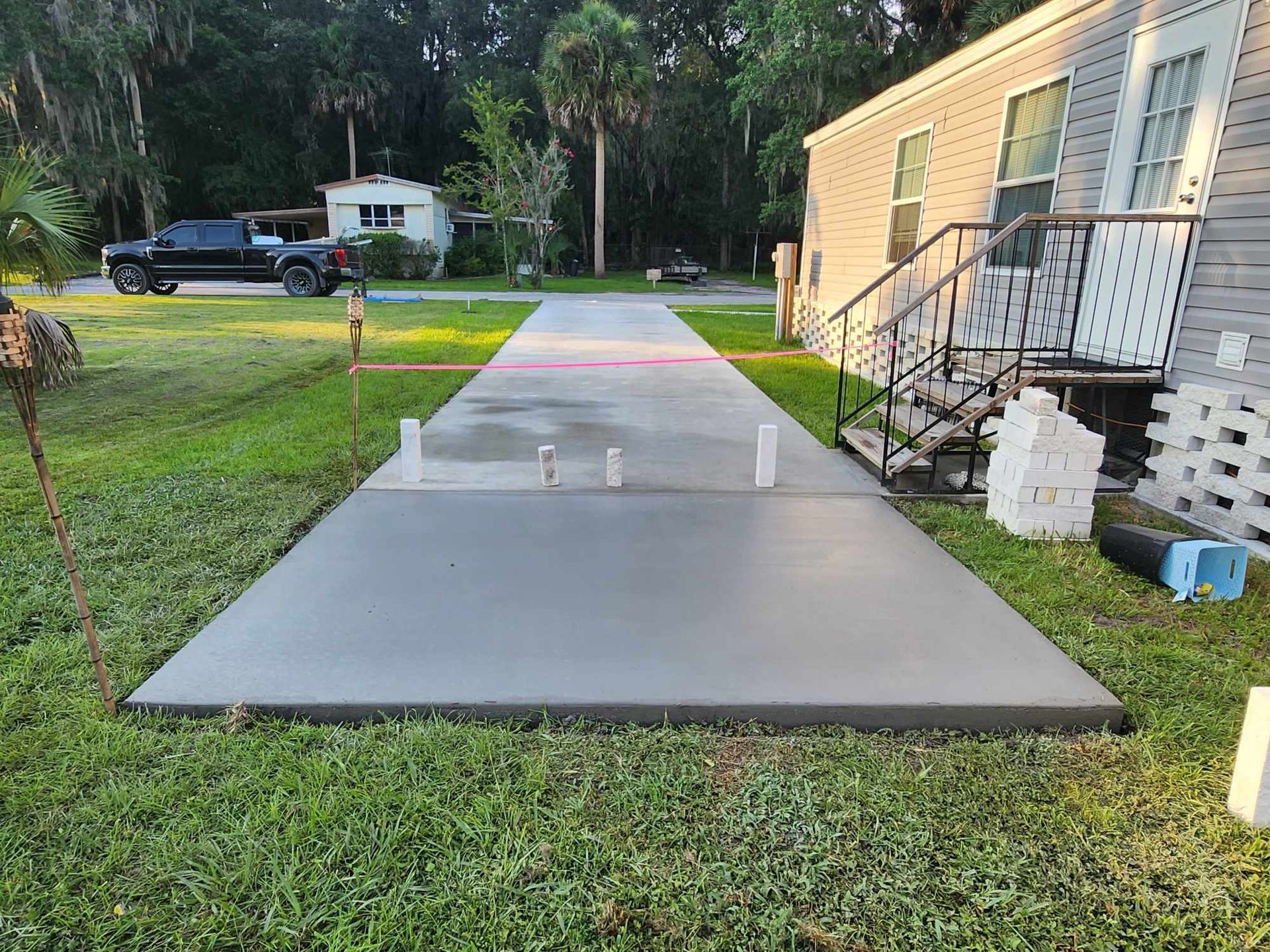 A concrete walkway leading to a mobile home