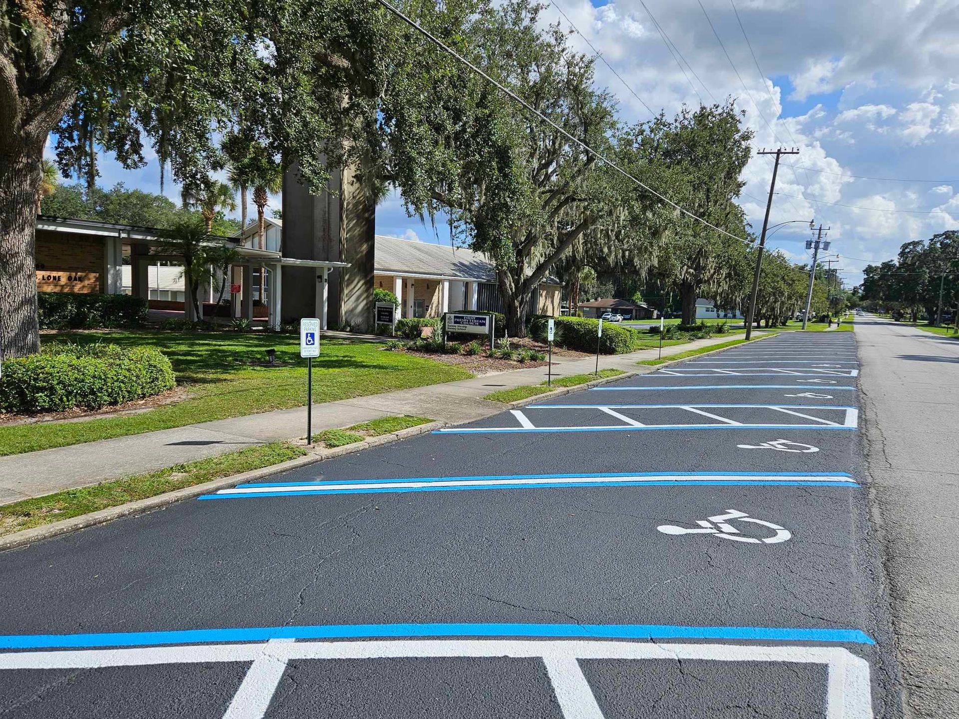 A row of handicapped parking spaces on the side of a road