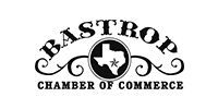 Bastrop Chamber of Commerce logo with arched text and a circular star-and-bow emblem