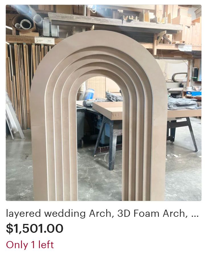 Layered beige wedding arch made of 3D foam in a workshop setting.