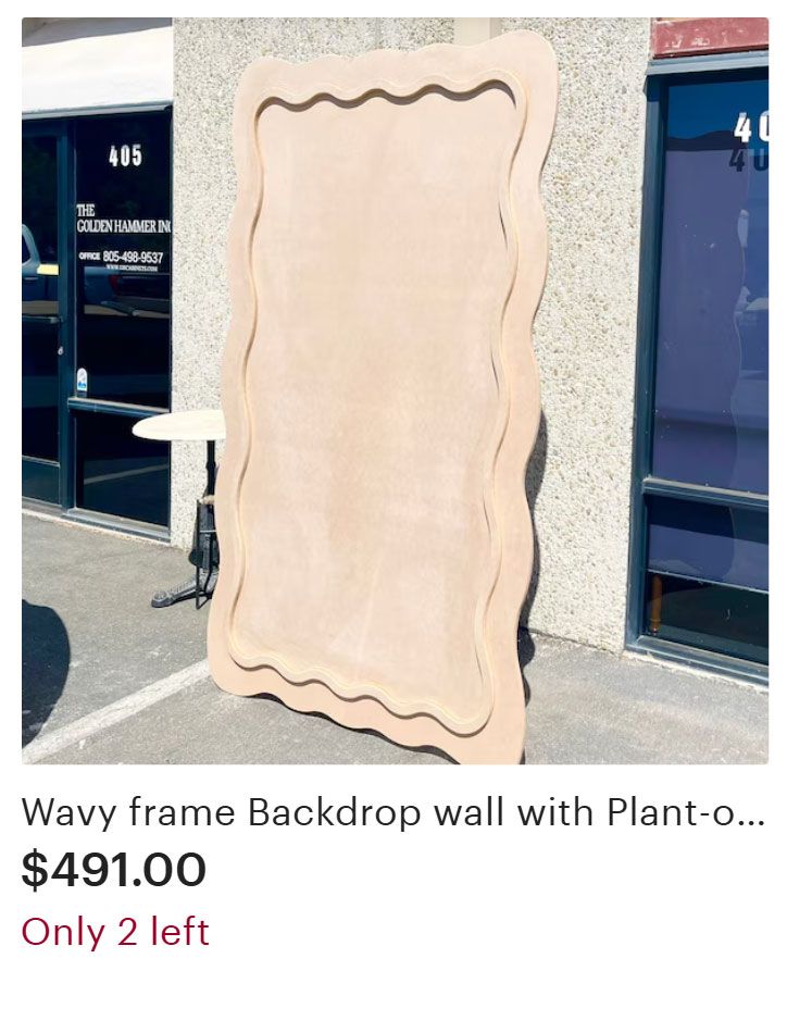 Wavy wooden frame leaning against a building, for a backdrop or wall decoration