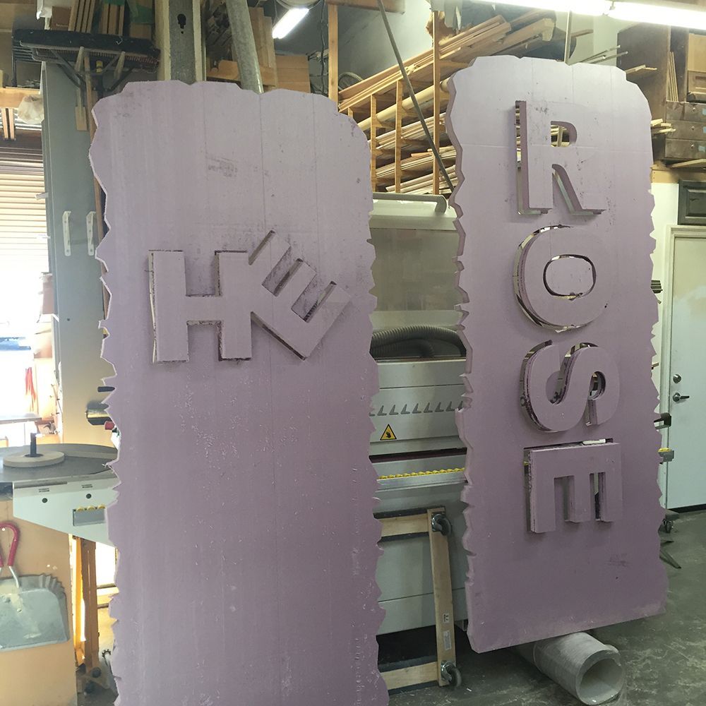 A purple sign with the word rose on it