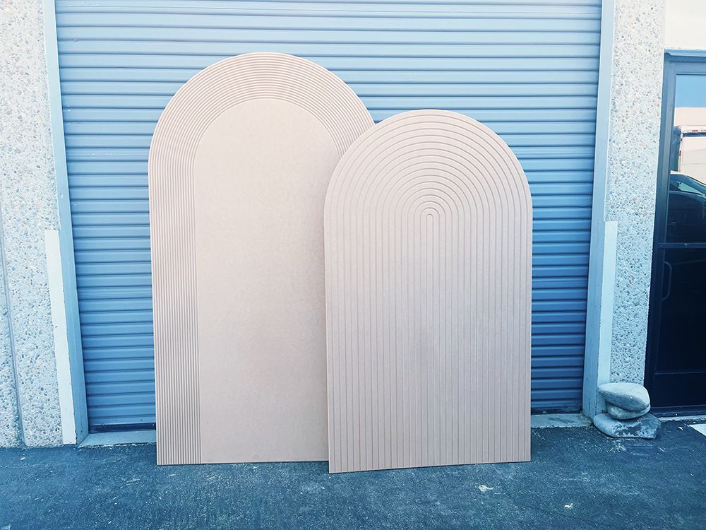 Two arches are sitting next to each other in front of a garage door