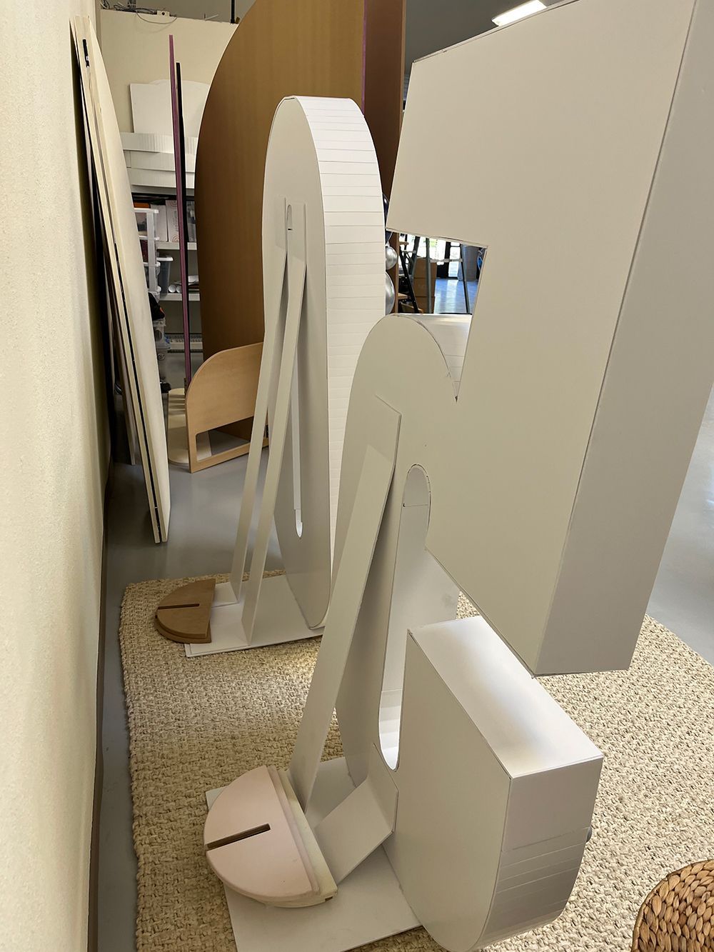 A large cardboard letter a is sitting on a rug