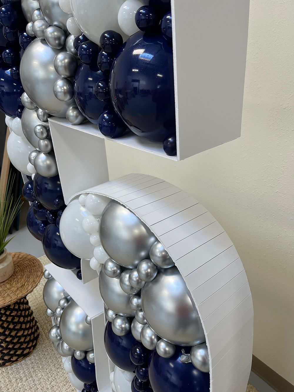 A large number 5 made of balloons is sitting on a table