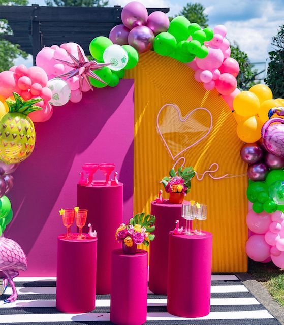 A purple and yellow wall with balloons and a heart drawn on it