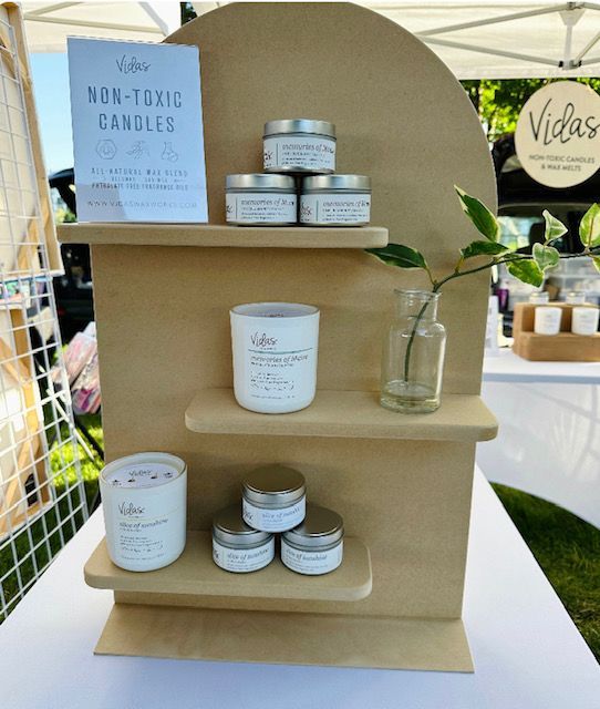 A wooden shelf with candles and a sign that says box-toxic candles