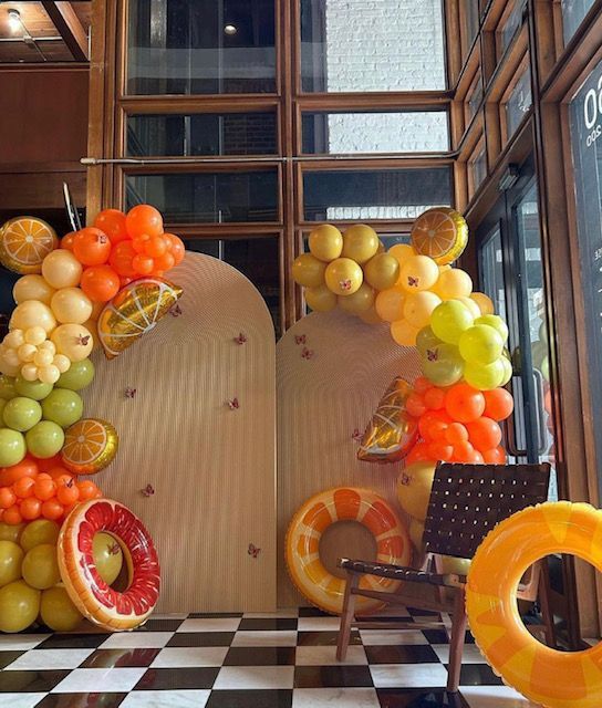 A room filled with fruit balloons and a chair