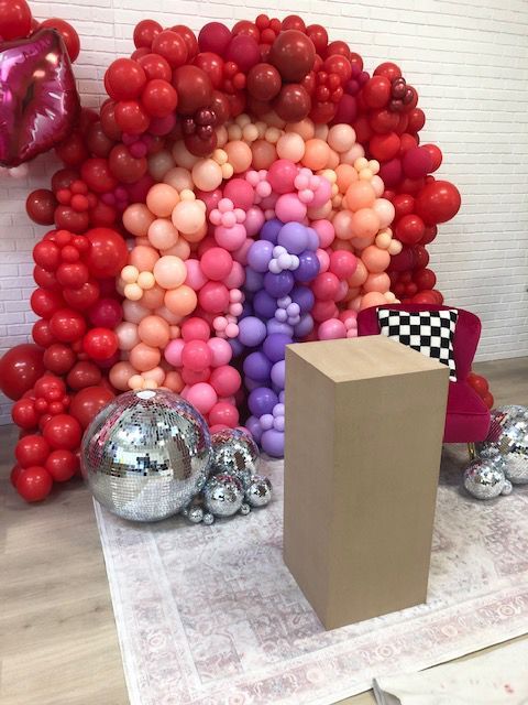 A room filled with balloons and a podium