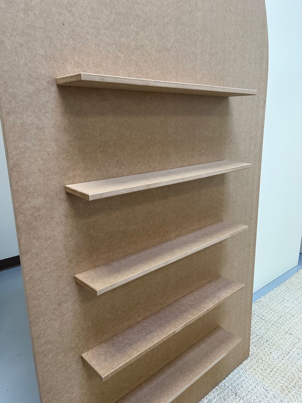 A wooden shelf is sitting on top of a wooden wall