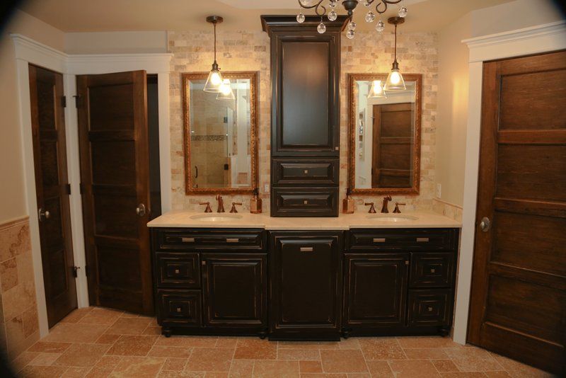 A bathroom with two sinks and two mirrors