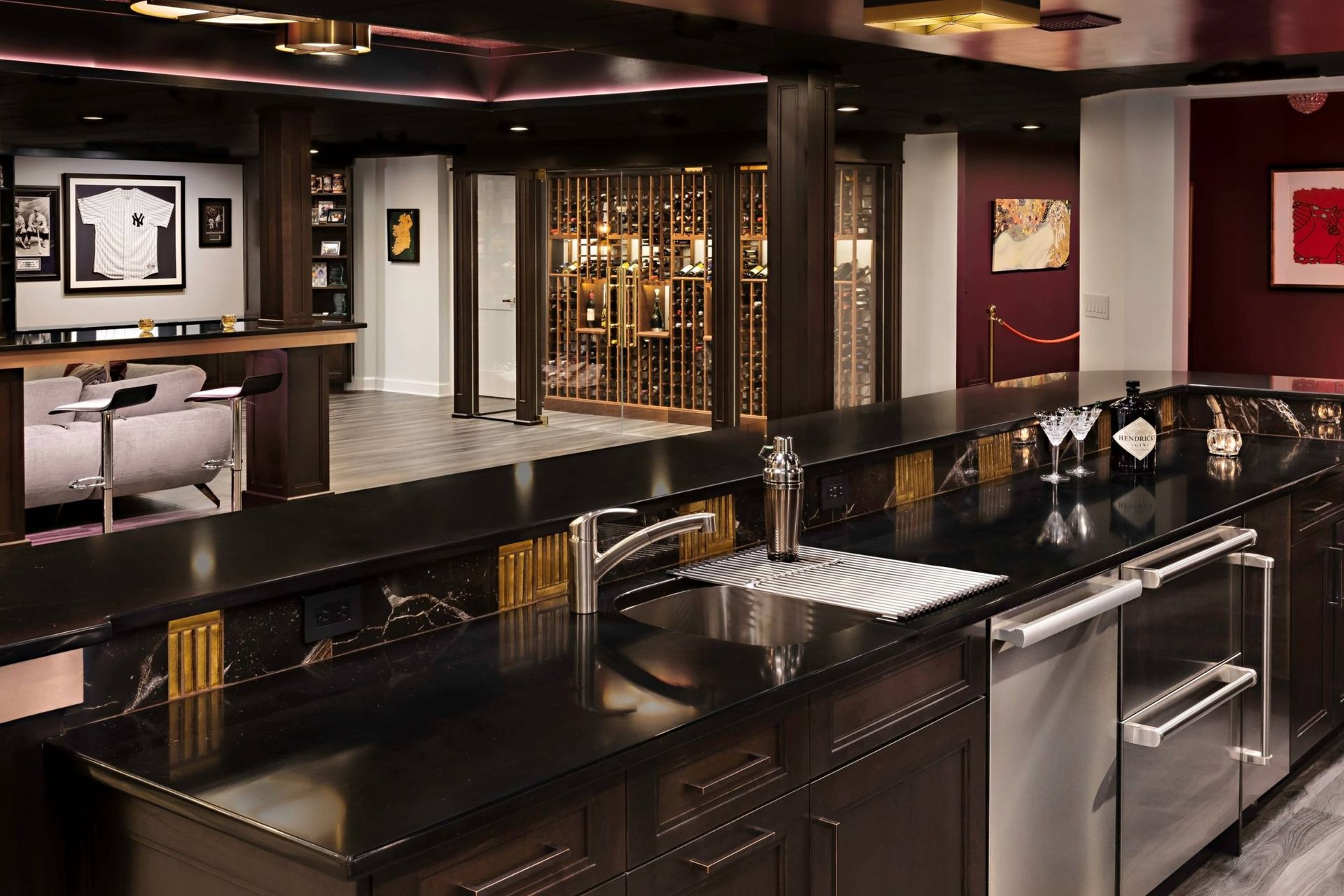 A kitchen with black counter tops and stainless steel appliances