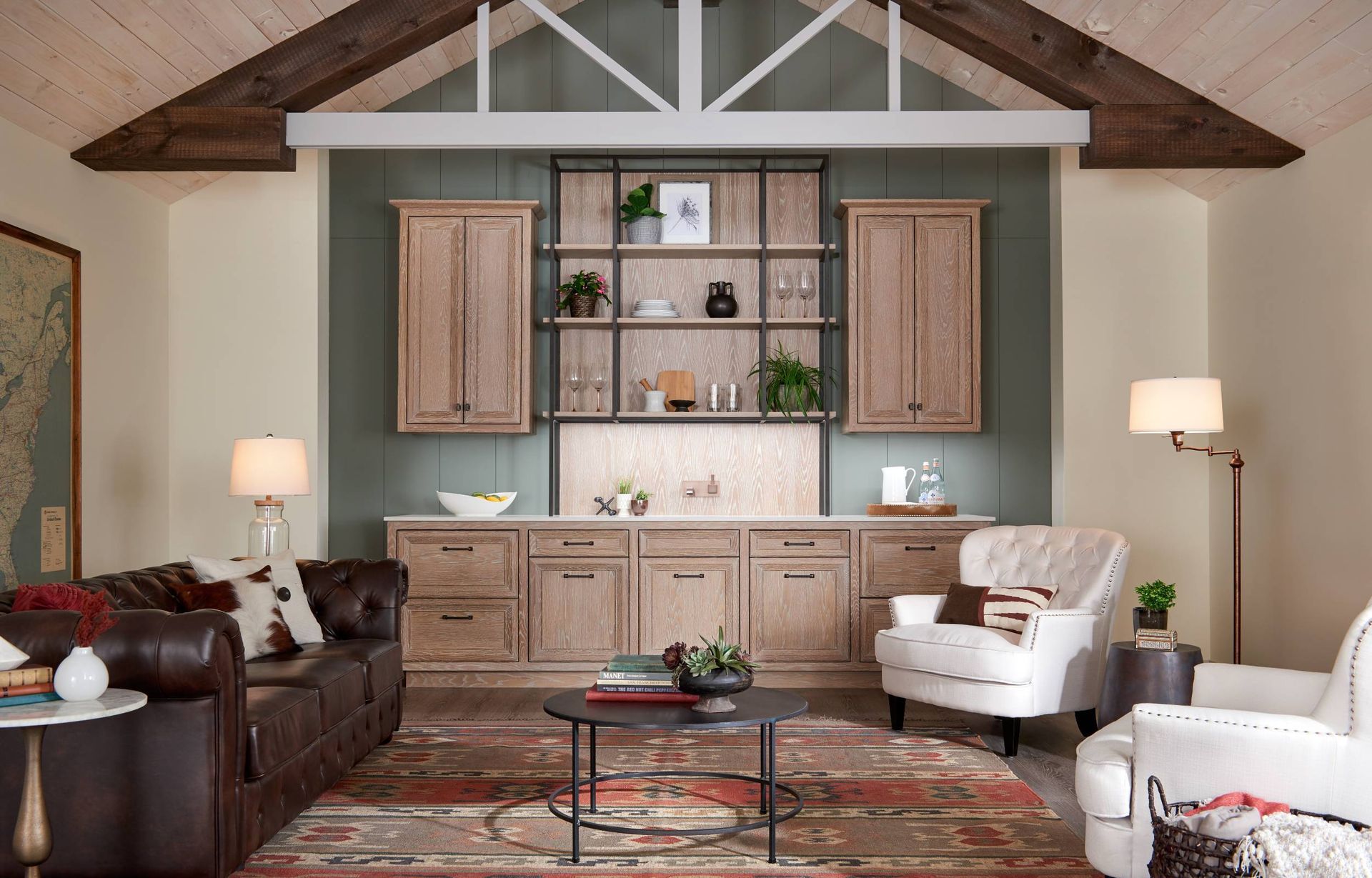 A living room with a couch , chair , coffee table , and shelves.
