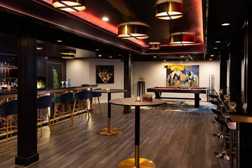 There is a pool table in the middle of the room.