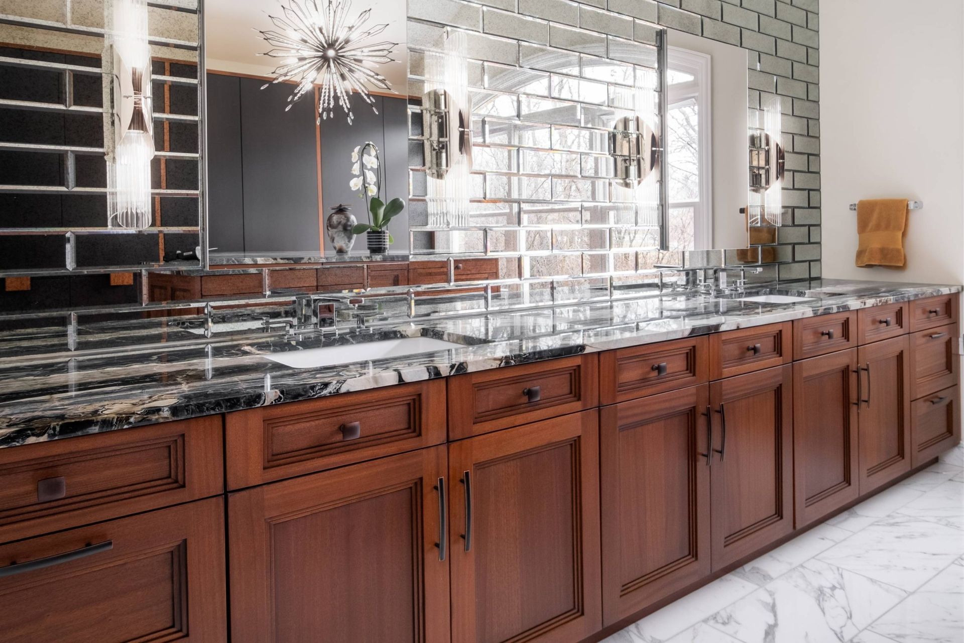 A bathroom with two sinks and a large mirror.