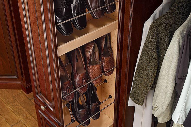 A closet with a shoe rack filled with shoes.