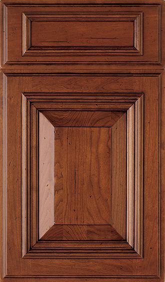 A close up of a wooden cabinet door on a white background.
