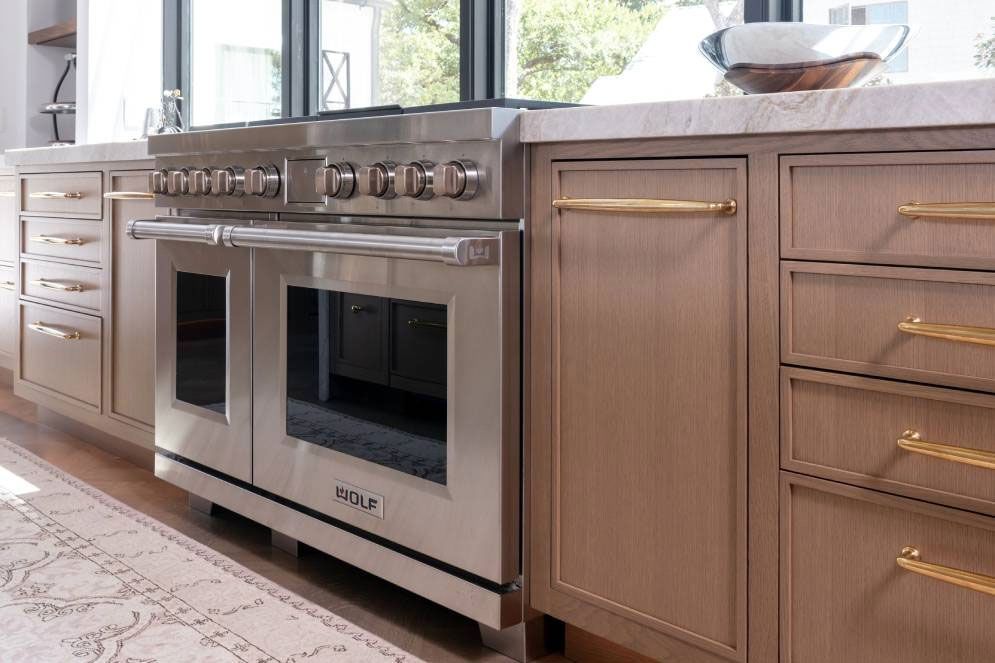 A kitchen with stainless steel appliances and wooden cabinets.