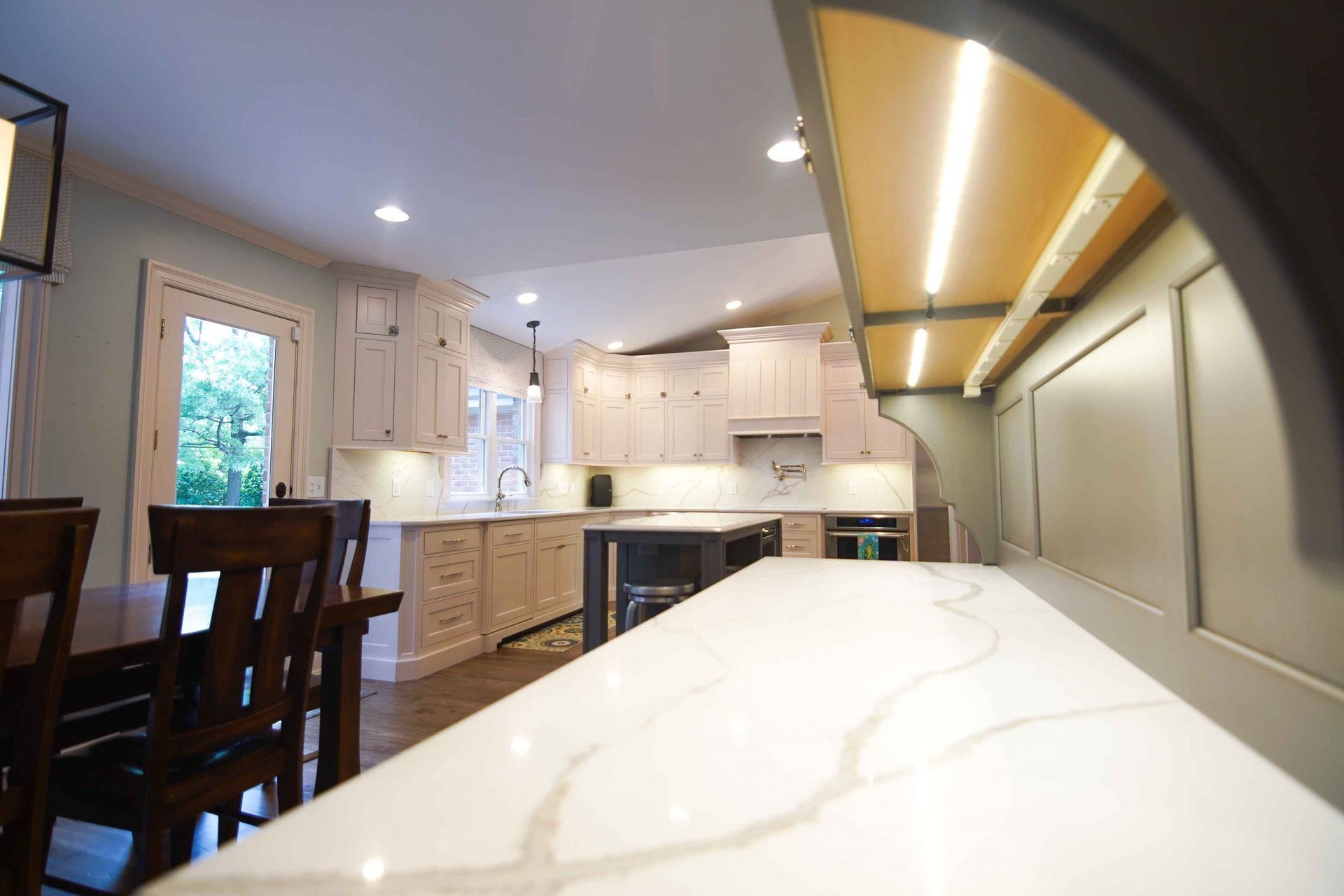 A kitchen with white cabinets and a white counter top.
