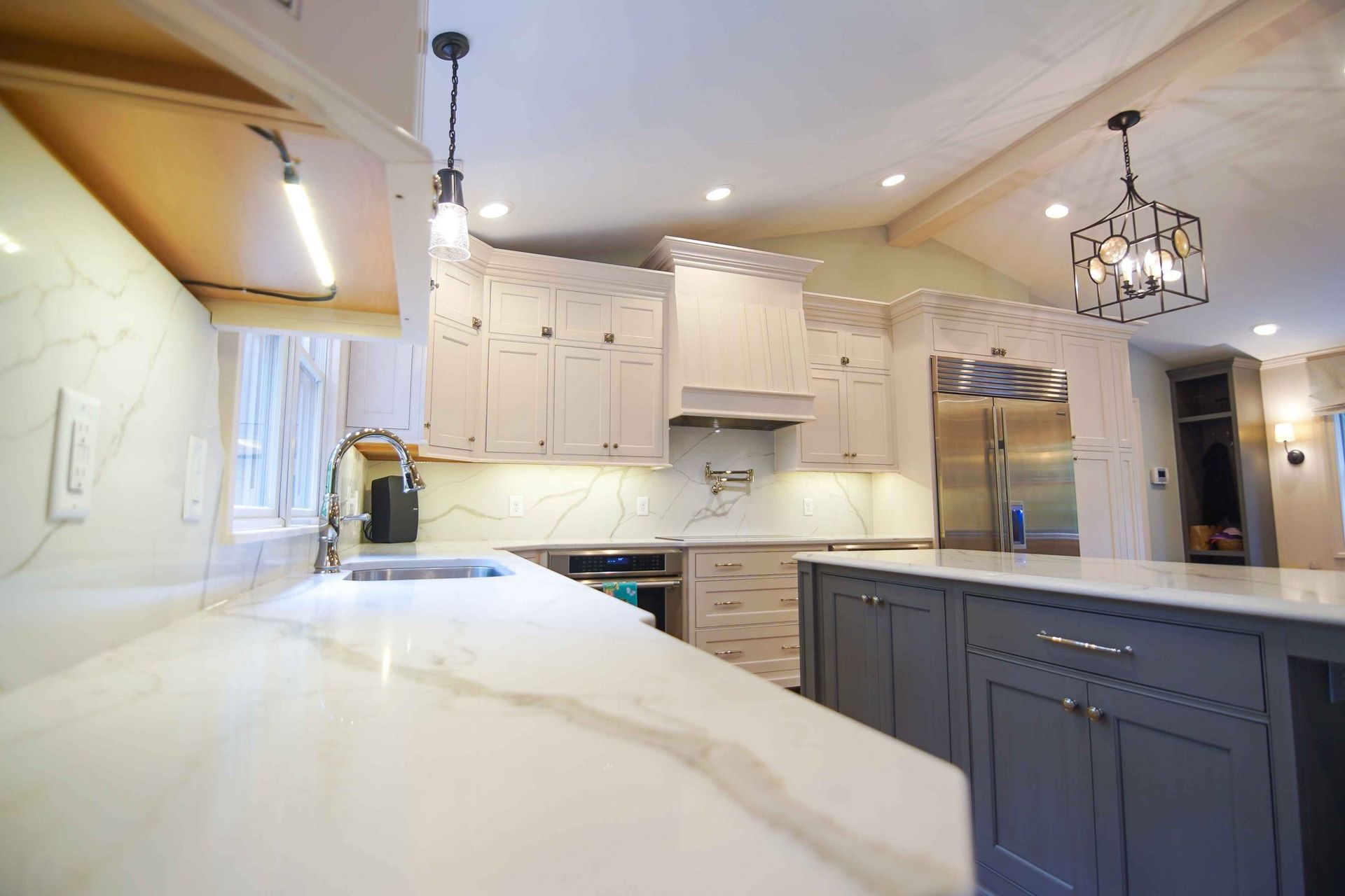 A kitchen with white cabinets and stainless steel appliances.