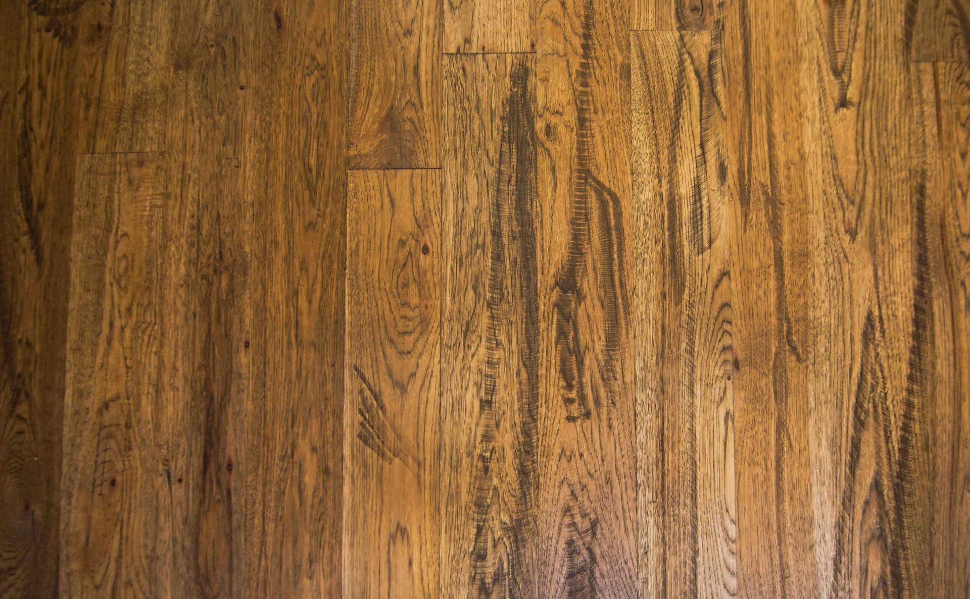 A close up of a wooden floor with a grainy texture.