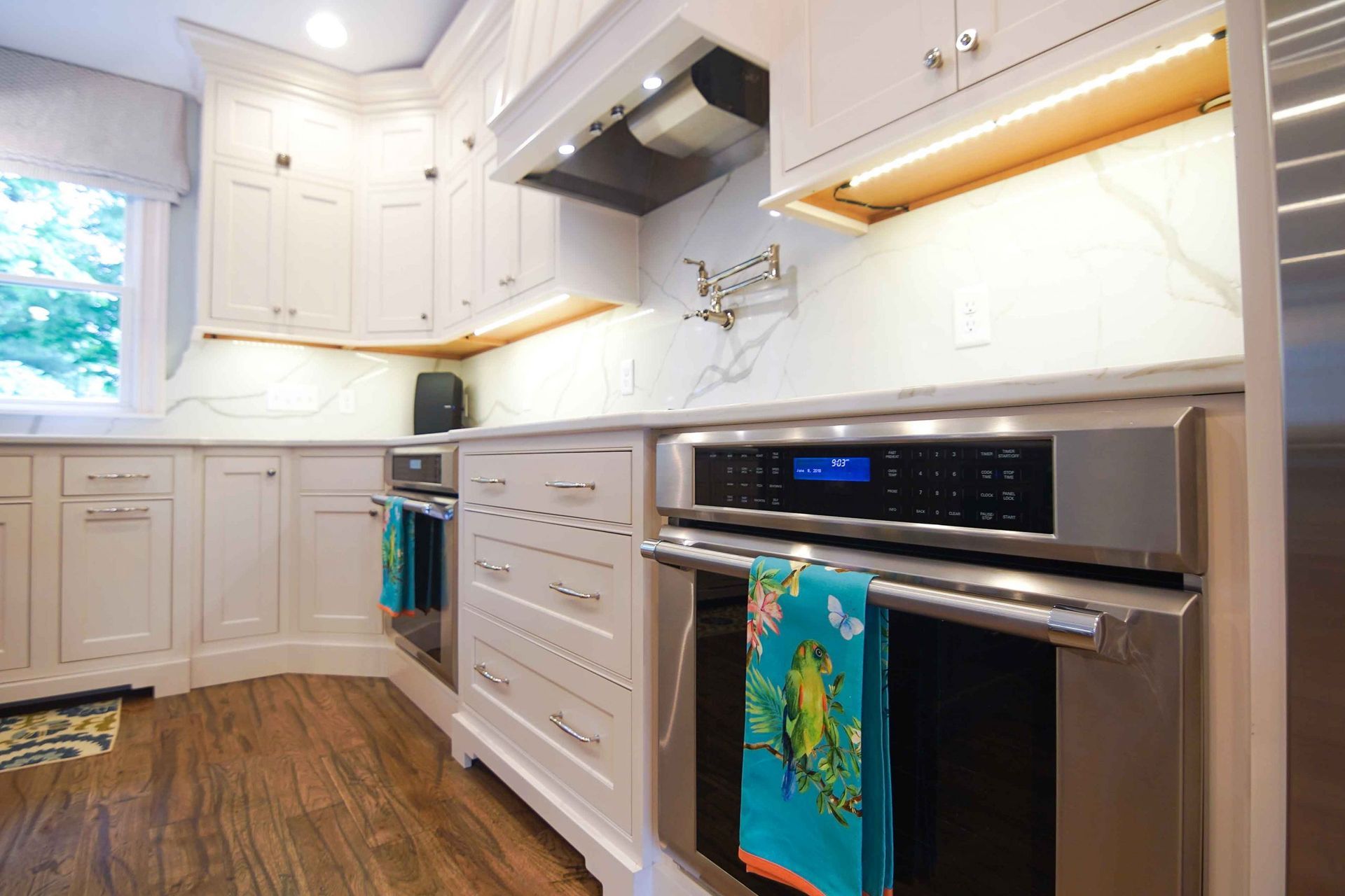 A kitchen with white cabinets and stainless steel appliances.