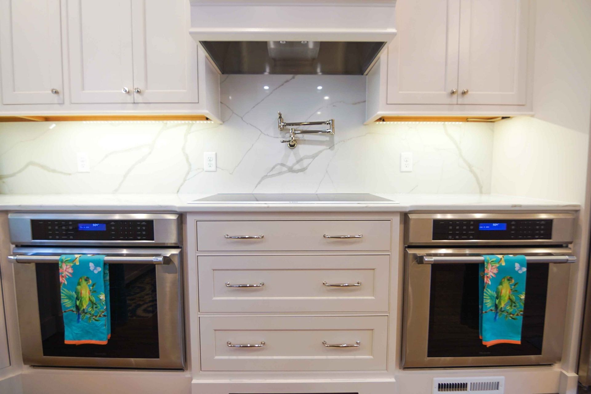 A kitchen with stainless steel appliances and white cabinets