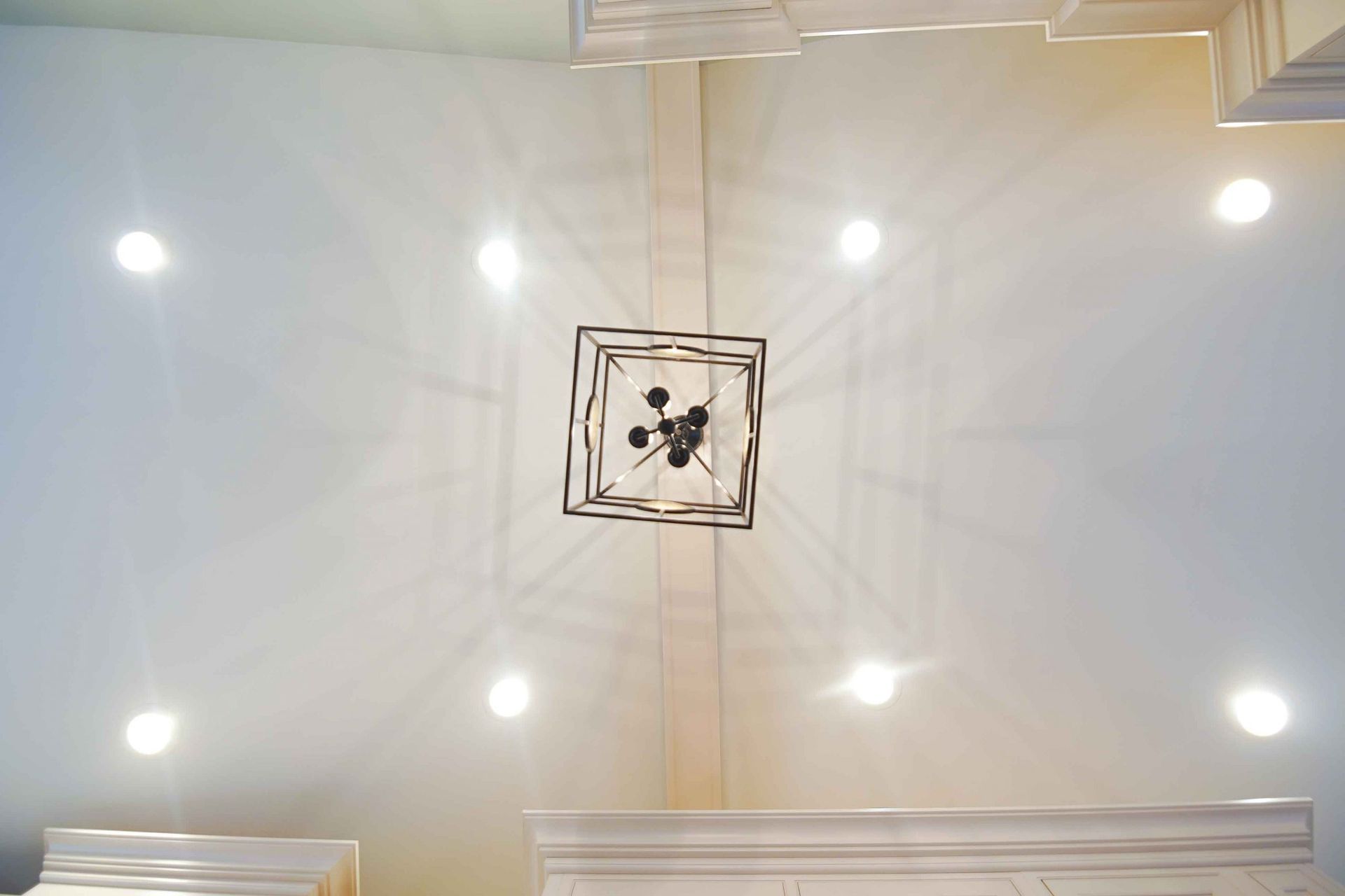 A chandelier is hanging from the ceiling of a room.