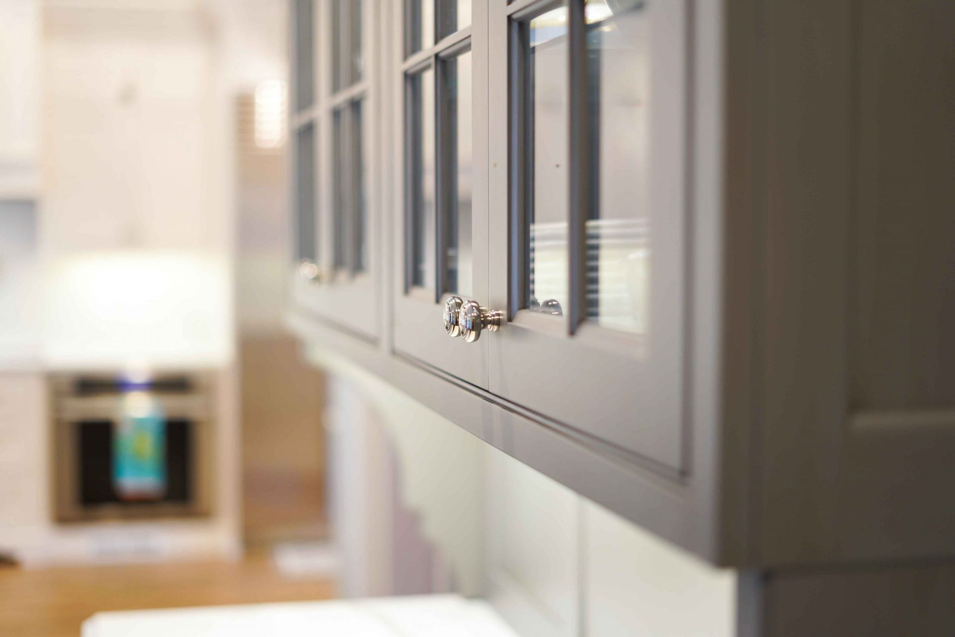 A close up of a kitchen cabinet with glass doors.
