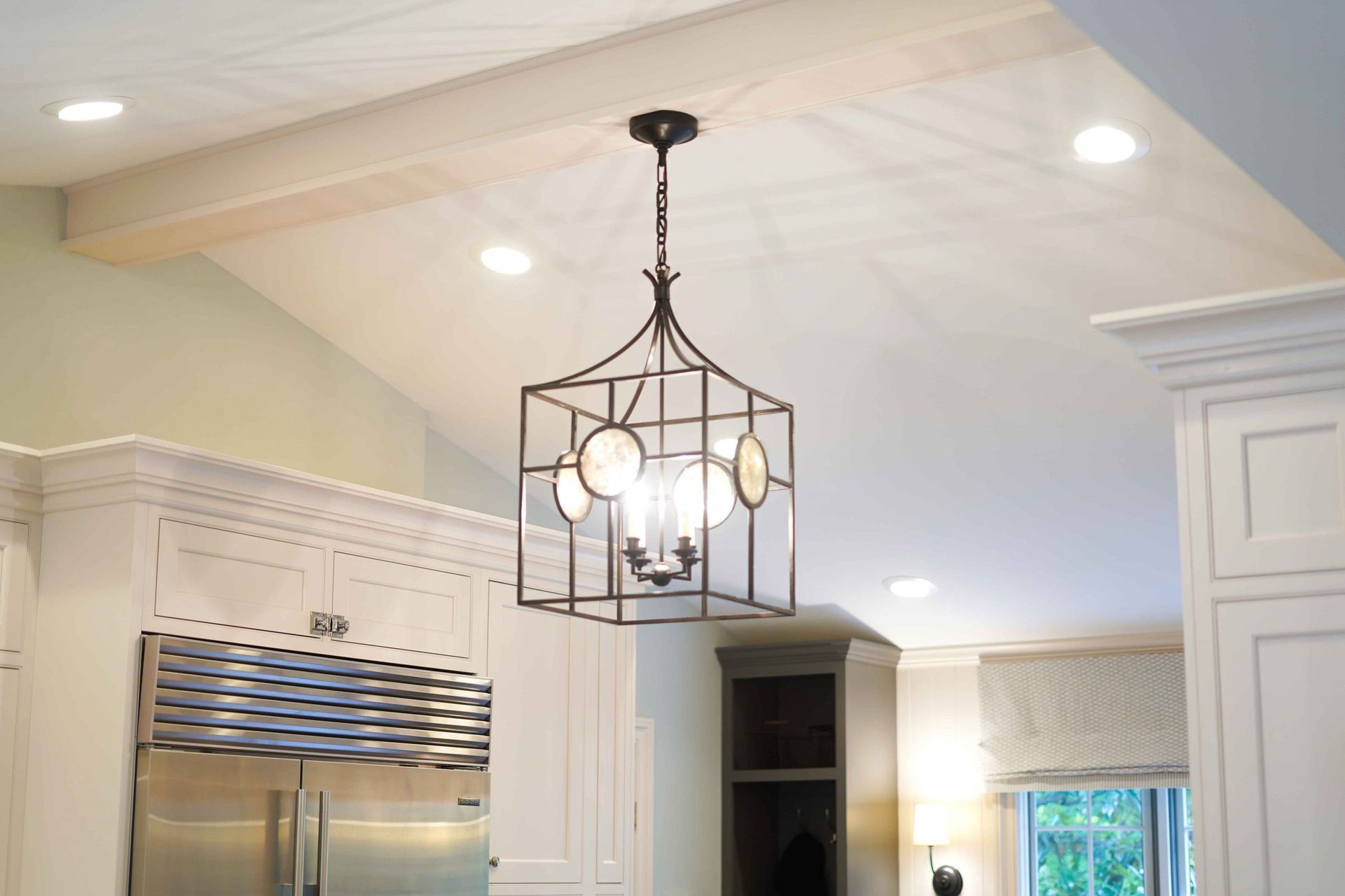 A kitchen with a chandelier hanging from the ceiling