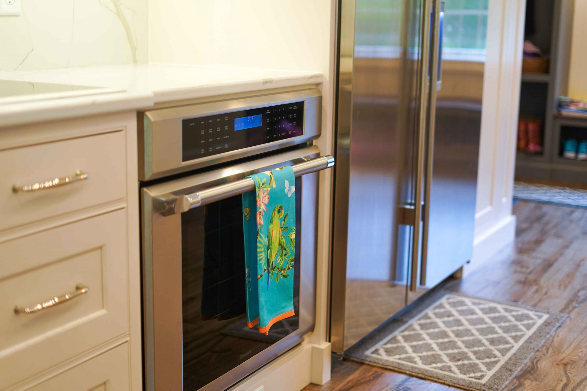 A kitchen with a stainless steel refrigerator and a stainless steel oven.