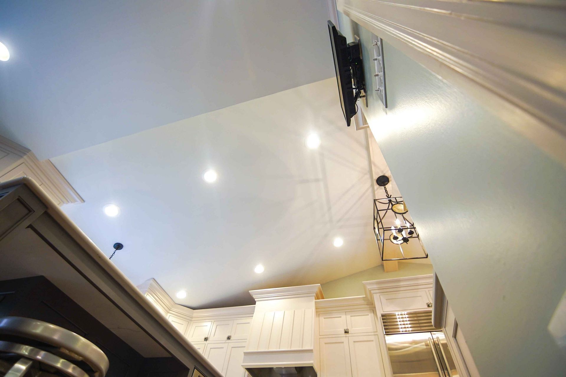 A kitchen with white cabinets and stainless steel appliances.