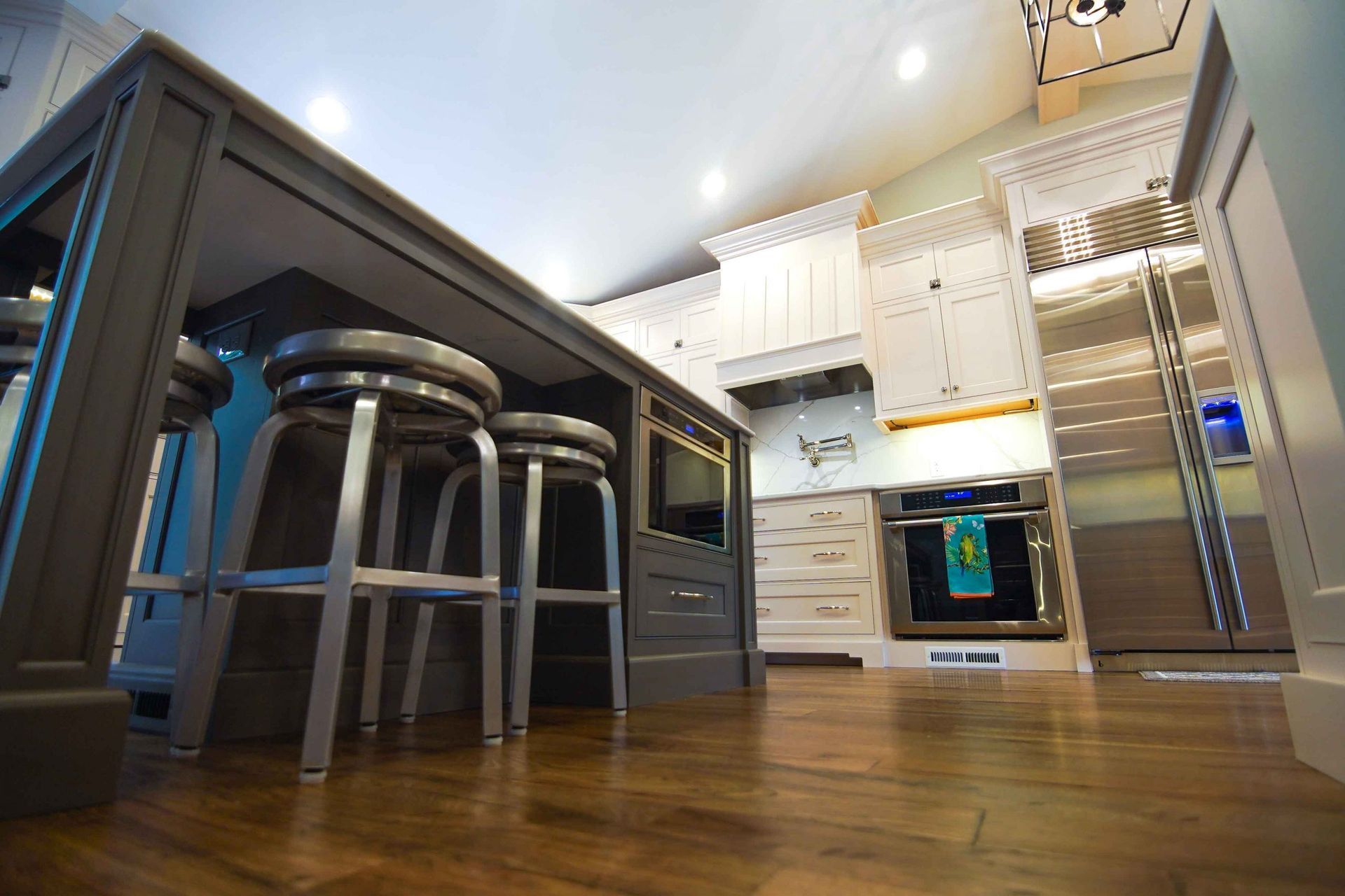 A kitchen with a table and stools in it