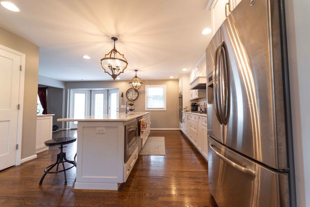 A kitchen with stainless steel appliances and a large island.