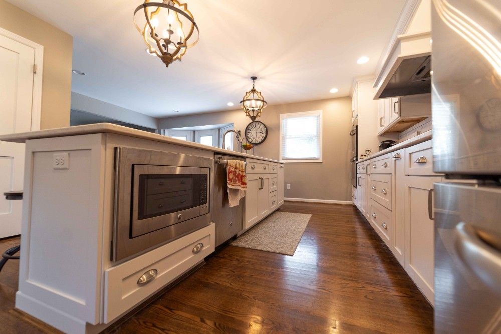 A kitchen with white cabinets and stainless steel appliances.